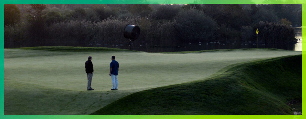 two men talking on course